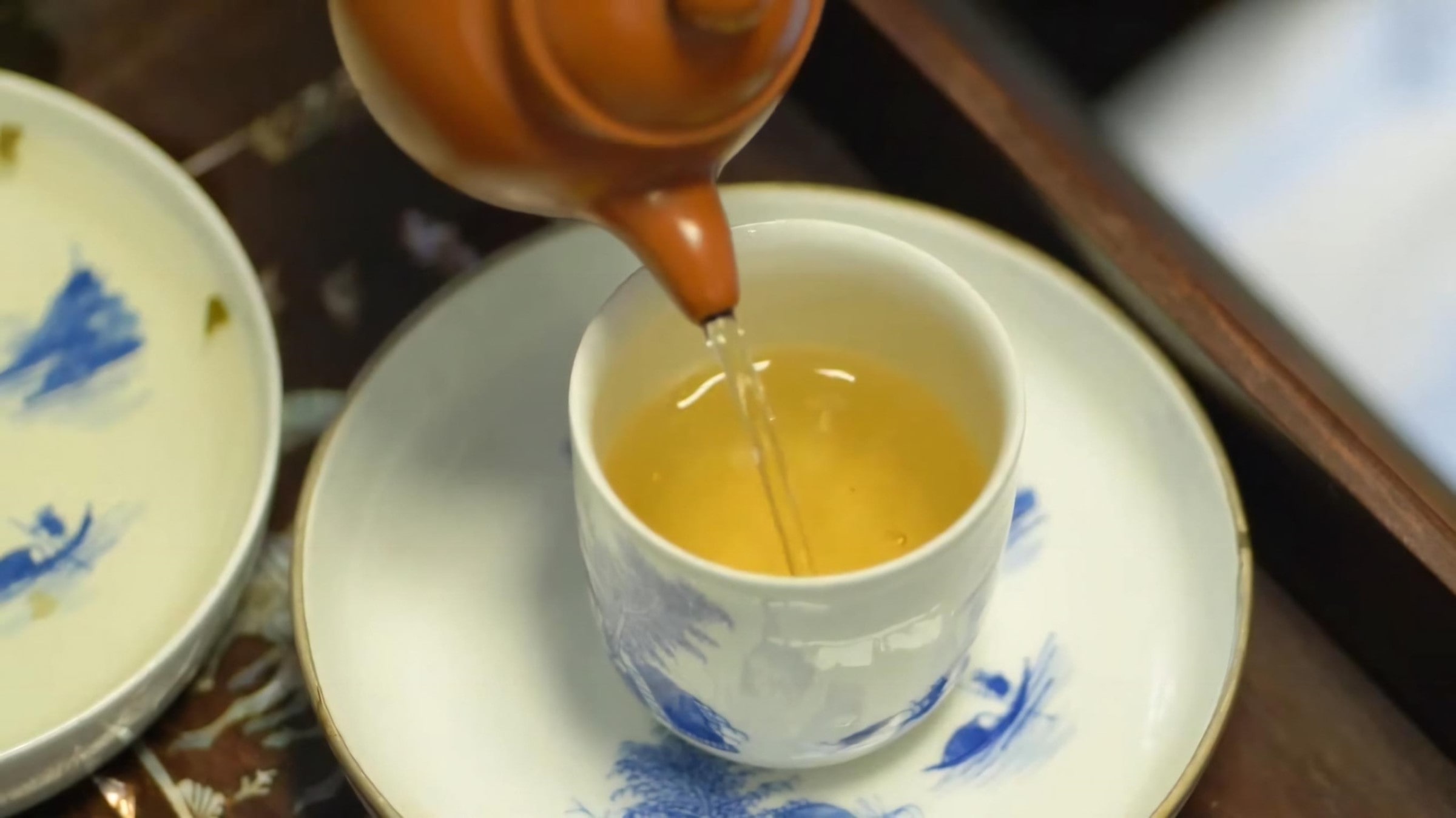 pour-tea-from-the-pot-into-the-serving-pitcher