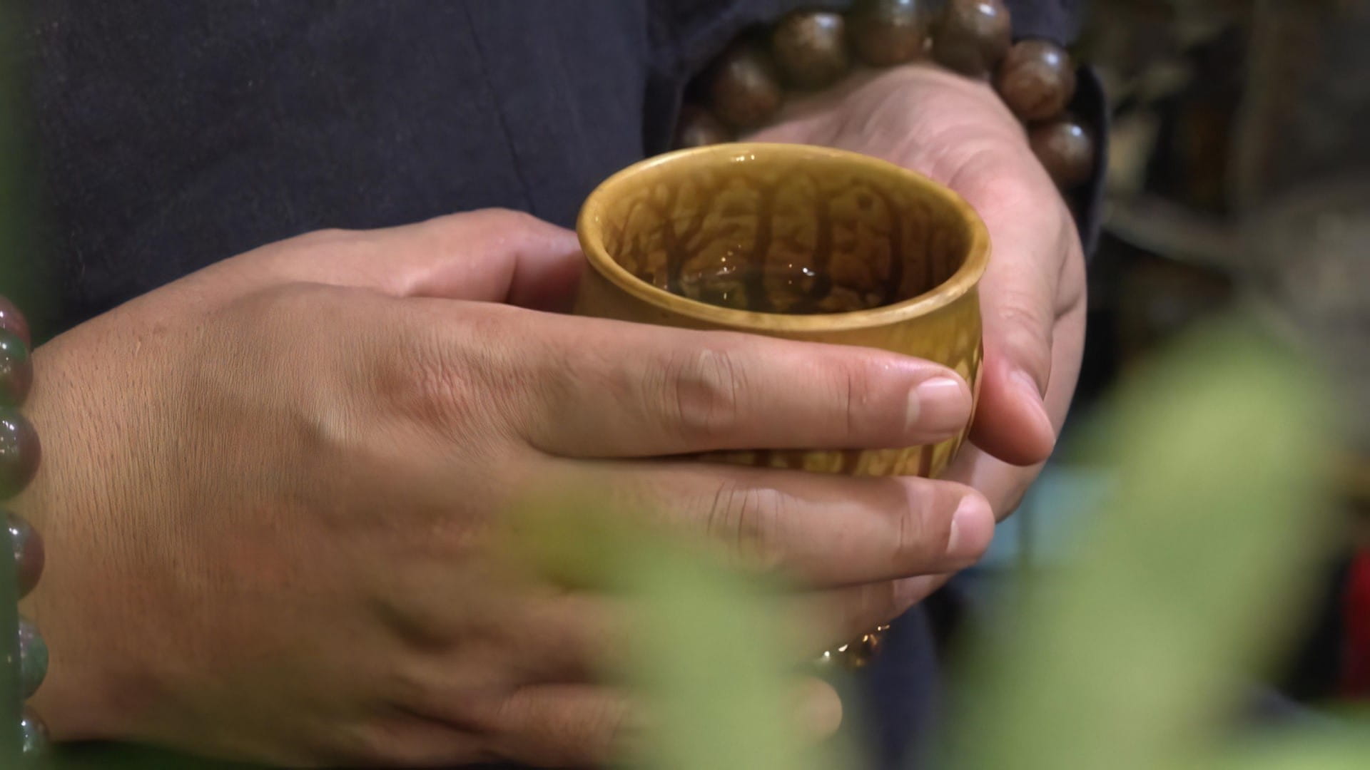 What Is West Lake Lotus Tea? 4 Tea-lover-slowly-raises-a-cup-of-lotus-tea-pausing-to-savor-its-fragrance